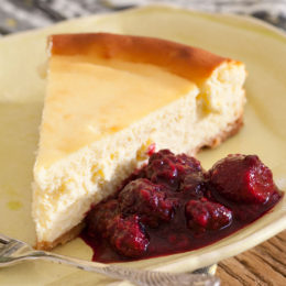 WHITE CHOCOLATE CHEESECAKE WITH BERRY REDUCTION