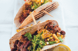 Tacos with vindaloo beans, crushed avocado and charred corn