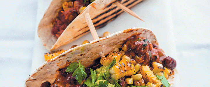 Tacos with vindaloo beans, crushed avocado and charred corn