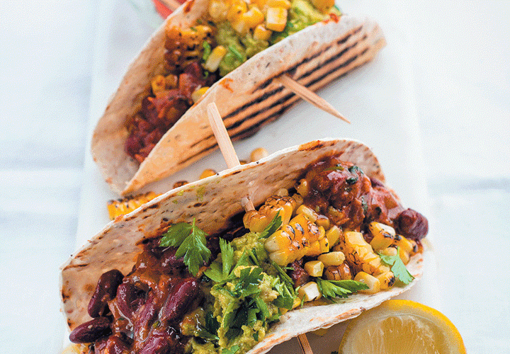 Tacos with vindaloo beans, crushed avocado and charred corn