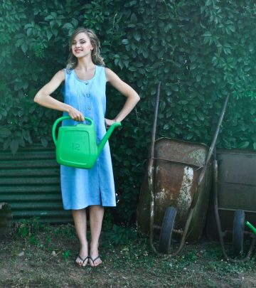 a woman posing in front of gardening tools