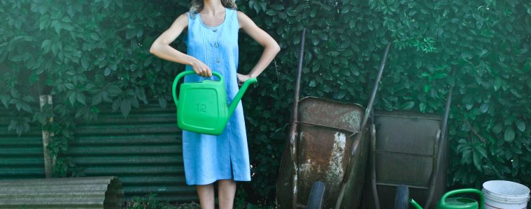 a woman posing in front of gardening tools