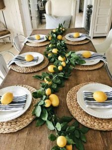 a table set with leaves and lemons