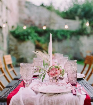 a table set outside with pink decor