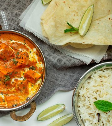 a dish with chicken stew in it alongside some rice