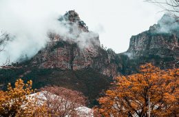 the franschhoek mountains in winter with brown trees and clouds