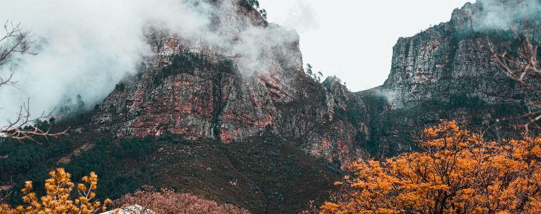 the franschhoek mountains in winter with brown trees and clouds