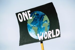 a protest placard saying one world
