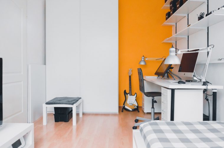 a room with a TV and a desk