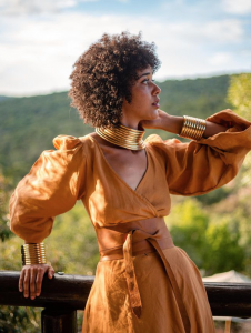 a stylish woman wearing earthy tones in nature