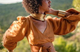 a stylish woman wearing earthy tones in nature