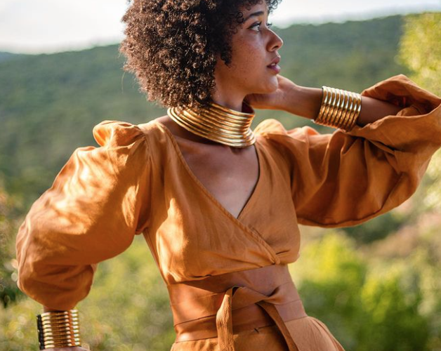a stylish woman wearing earthy tones in nature
