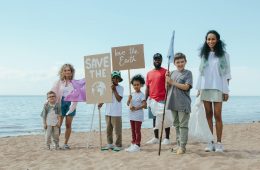 a group of volunteers cleaning a beach