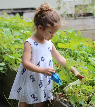 a girl watering the garden