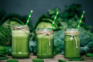 Broccoli Juice Blended green smoothie with ingredients on wooden table