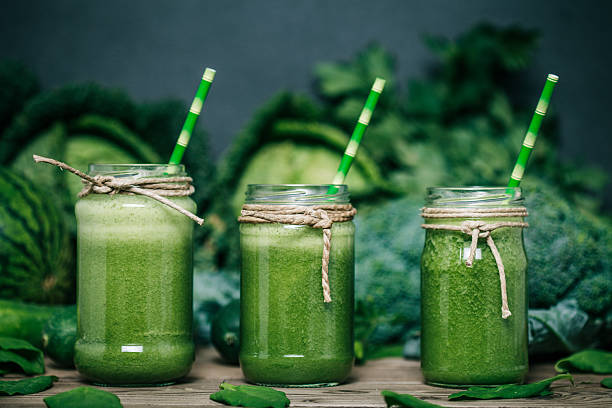 Broccoli Juice Blended green smoothie with ingredients on wooden table