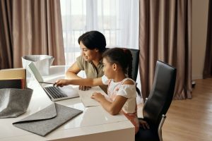A parent with their child doing home and studying