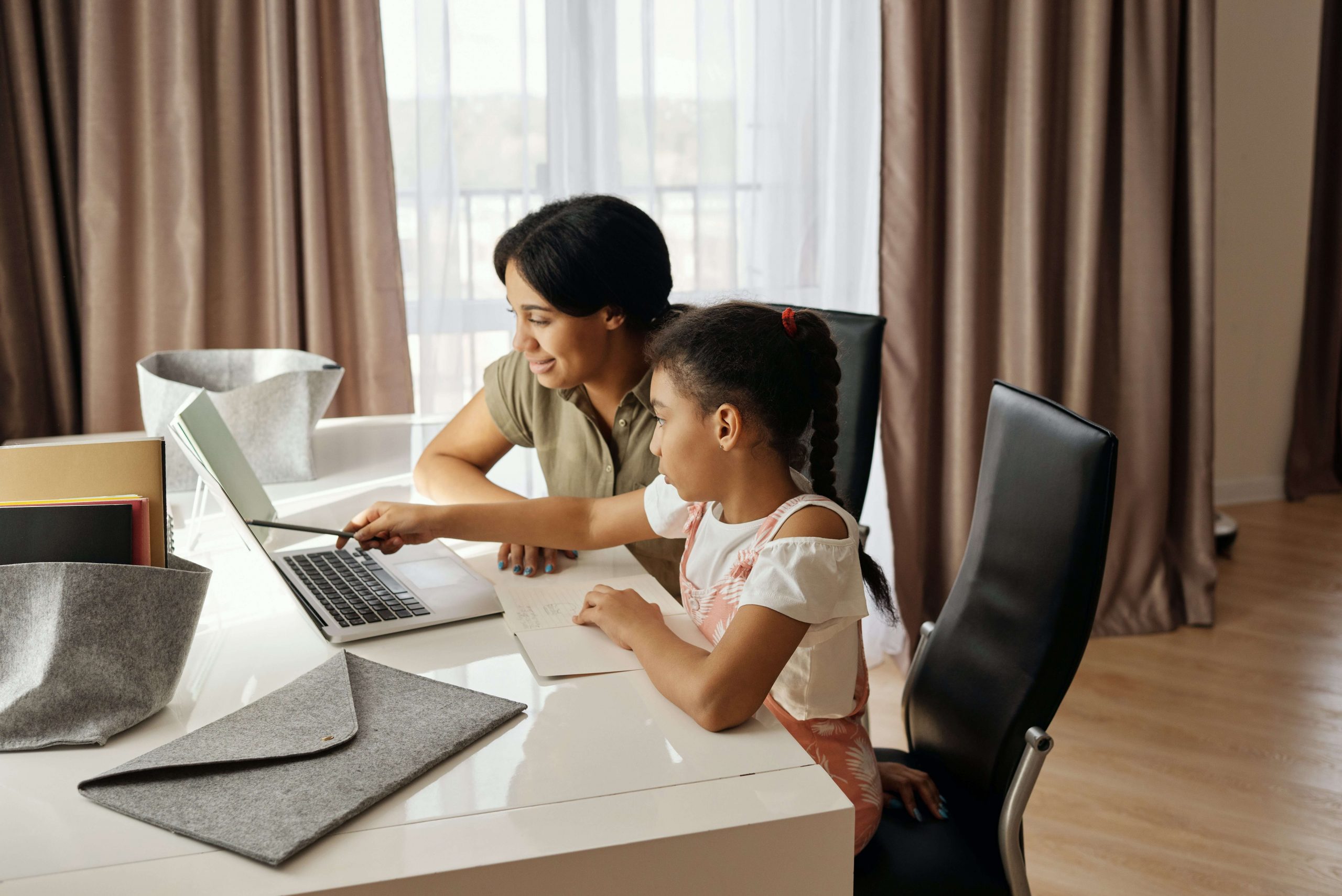 A parent with their child doing home and studying 