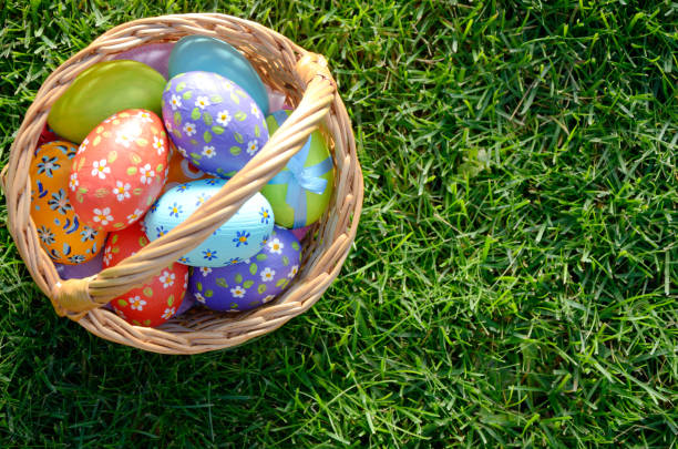  Easter eggs in the wicker basket on green spring grass. 