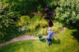 Aerial view of a man maintaining his garden lawn.