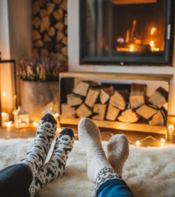 A couple on a lazy winter day in front of fire in fireplace.