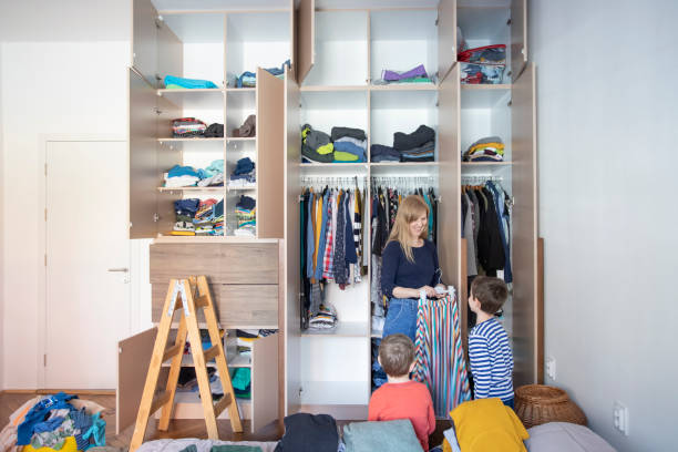 Kids helping their mother to organize closet