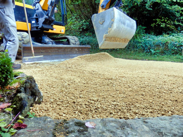 Gravel driveway being rolled flat