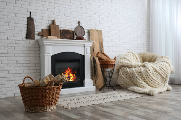 Firewood and white fireplace in cozy living room