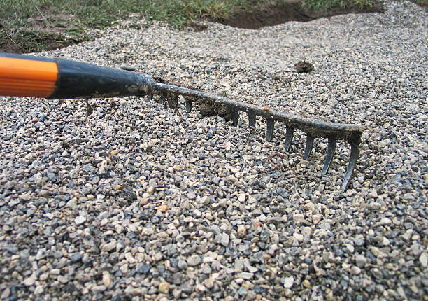 Rake, flattening out bed of gravel DRIVEWAY
