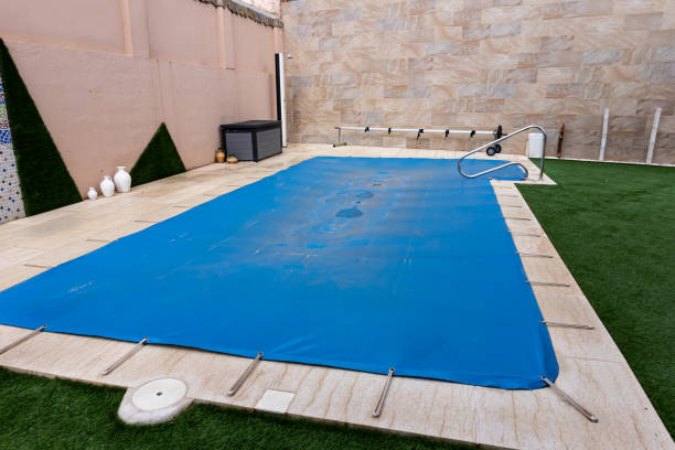 Small pool covered with a blue cover during the winter season 