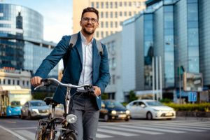Businessman with Backpack Commuting to Work With His Bicycle in City center