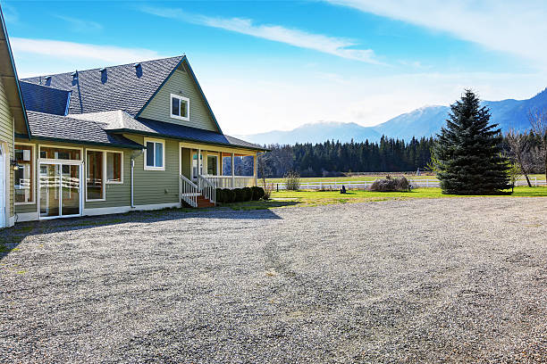 Back yard house with porch and gravel driveway