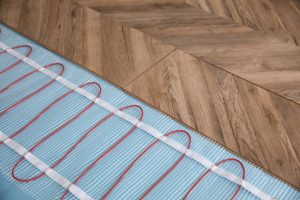 Installation of modern underfloor trace heating system indoors