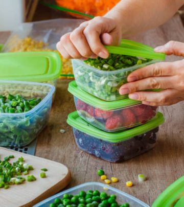 Woman preserving foods in containers before freezing