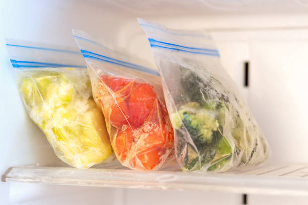 Frozen vegetables in plastic bags in freezer 