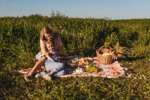 Outdoors garden picnic with mother and daughter