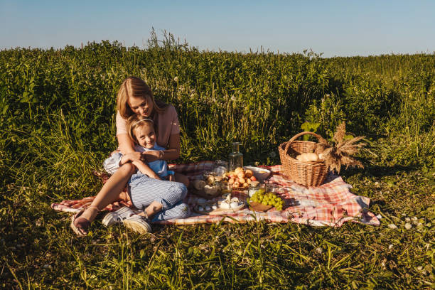 Outdoors garden picnic with mother and daughter 