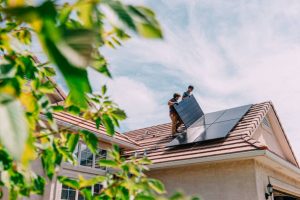 Installing solar panels on roof of home