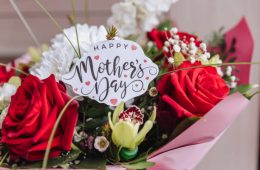 Happy Mothers Day text on gift card with flower bouquet of roses, tulips