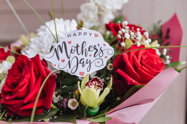 Happy Mothers Day text on gift card with flower bouquet of roses, tulips