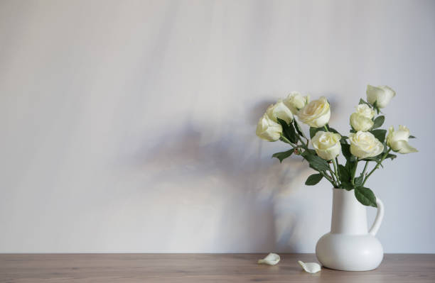 white roses in white jug for mothers day