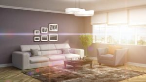 Interior with sofa and open windows letting the sunlight in