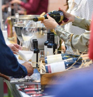 Hostess serving wine at wine fair event in Cape Town