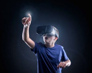 Boy experiencing using a virtual reality gaming system