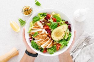 Low carb diet heavy with grilled chicken meat and fresh vegetable salad