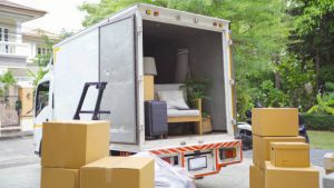 Truck car moving house for customers, delivering boxes and furniture.