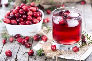 Chilled of Cranberry Juice in a glass with cranberry fruits on the side
