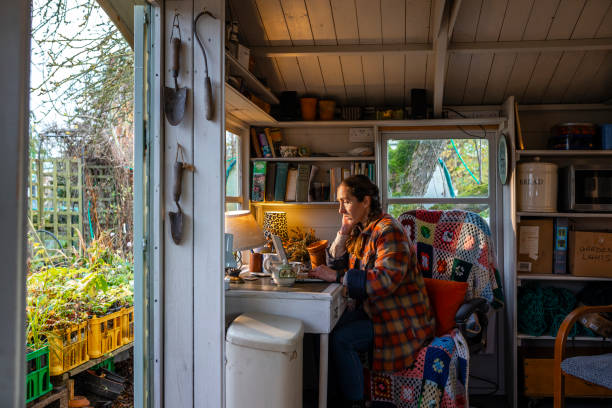 woman sitting in her garden shed in summer