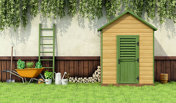 Garden with gardening tools and wooden shed with closed door