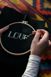 Embroidering the word LOVE